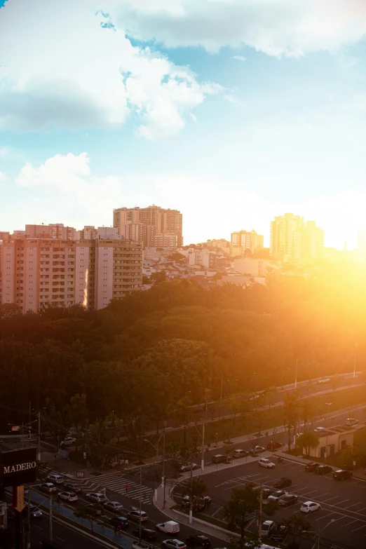 the setting sun shines brightly over a city with high rise buildings