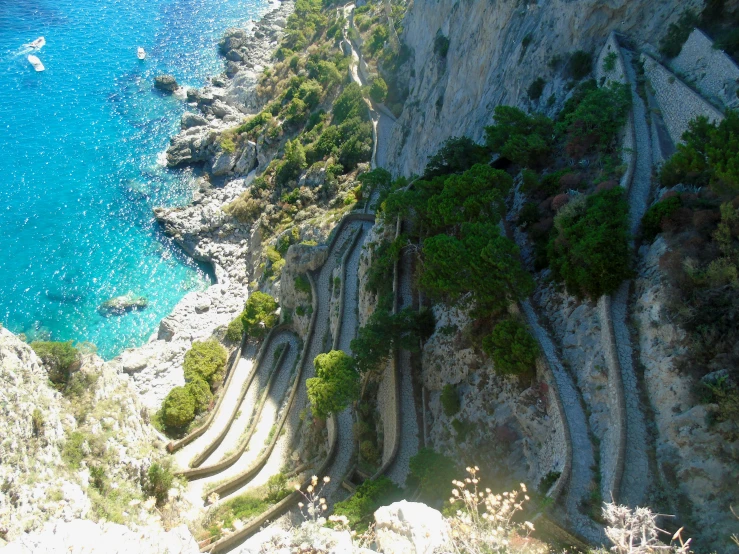 some water stairs that are next to a rocky cliff