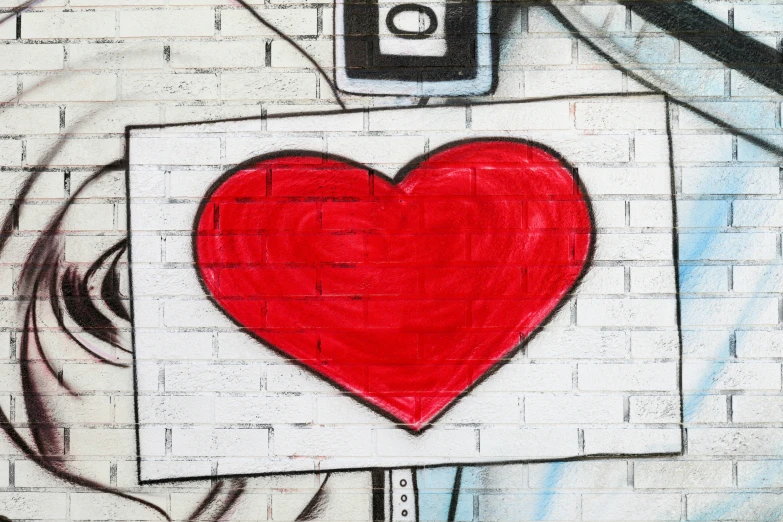 a red heart is painted on a white brick wall
