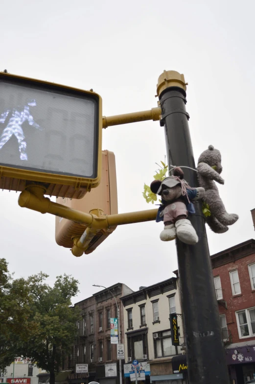 someone holding onto a teddy bear on the light