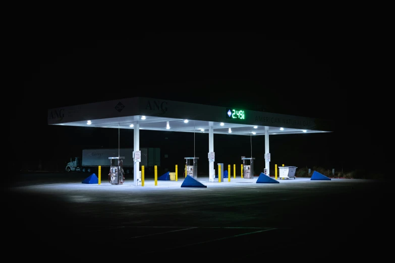 a gas station at night in the dark