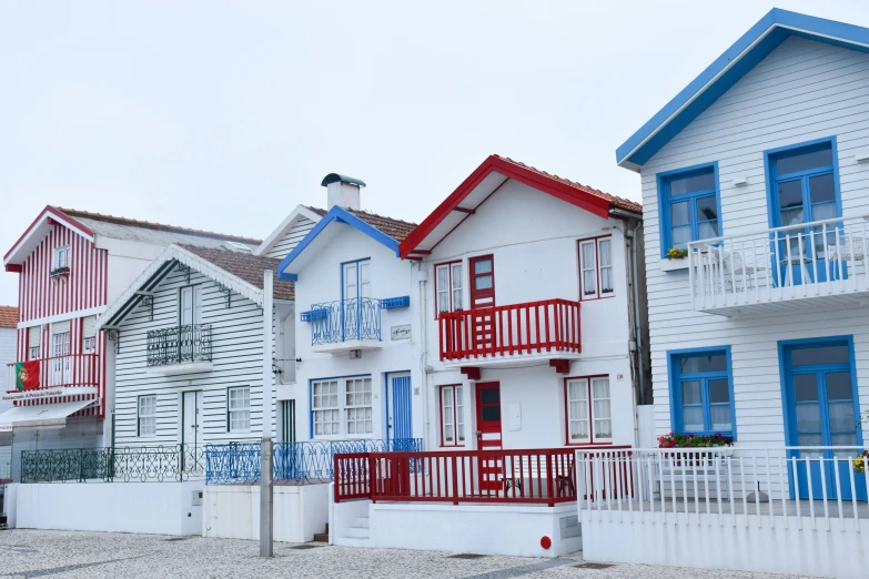 three blue and white buildings one of them is blue and red