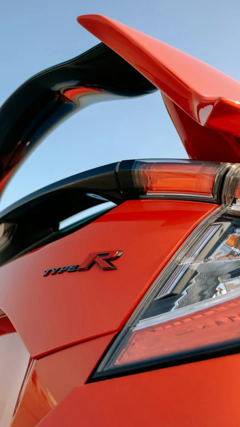 closeup of an orange sports car's headlight