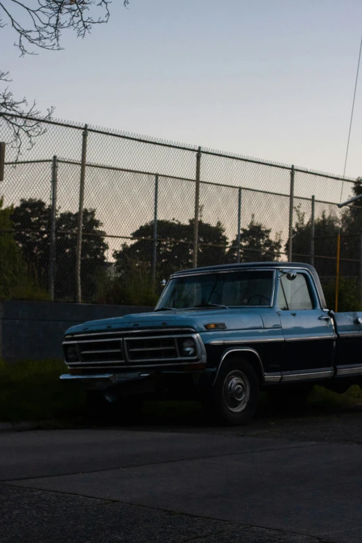 a black truck parked next to a fence