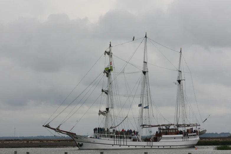 people on the side of a white boat