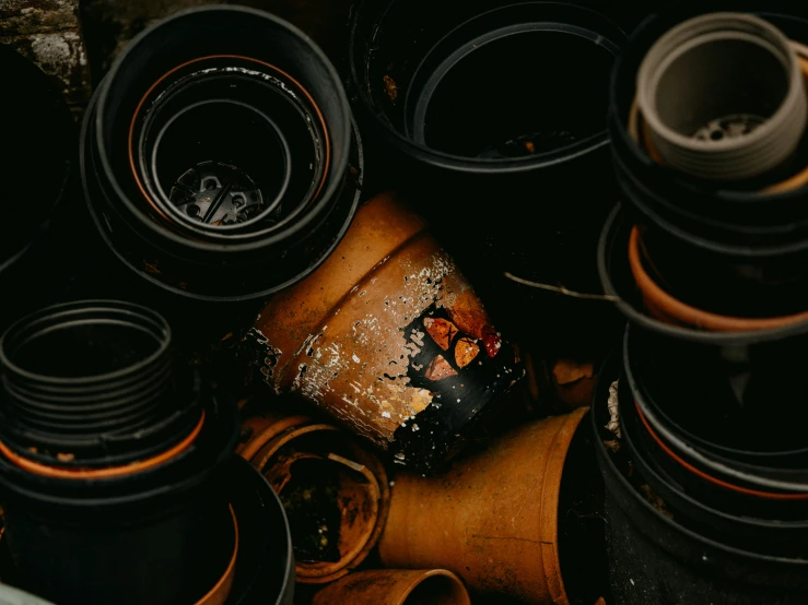 stacks of rolled up pots and bowls with some art work