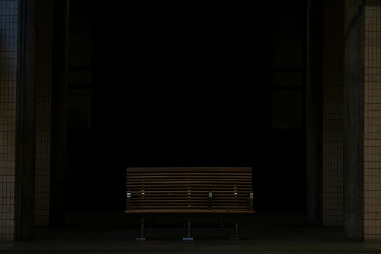 a dark po of a wooden bench in a brick hallway