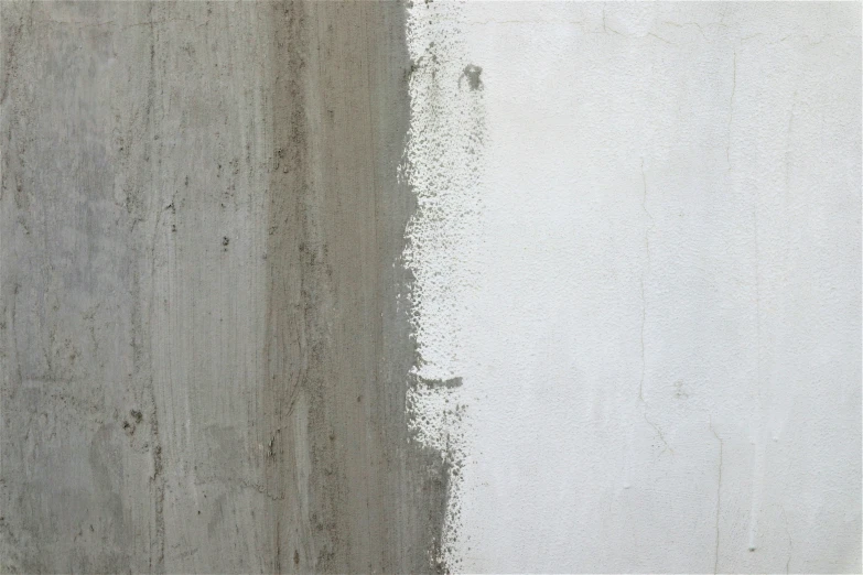 a white wall with paint chipping and dirt