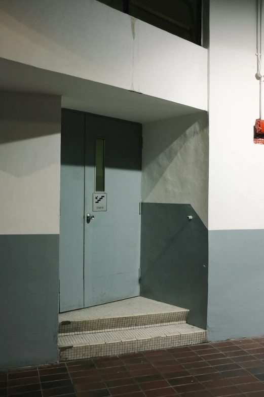 an empty elevator is next to stairs and light