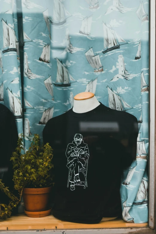 a shirt with an image of the character from star wars printed on it is shown behind a window