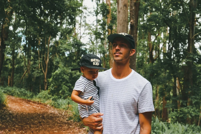 man holding child while posing for a picture