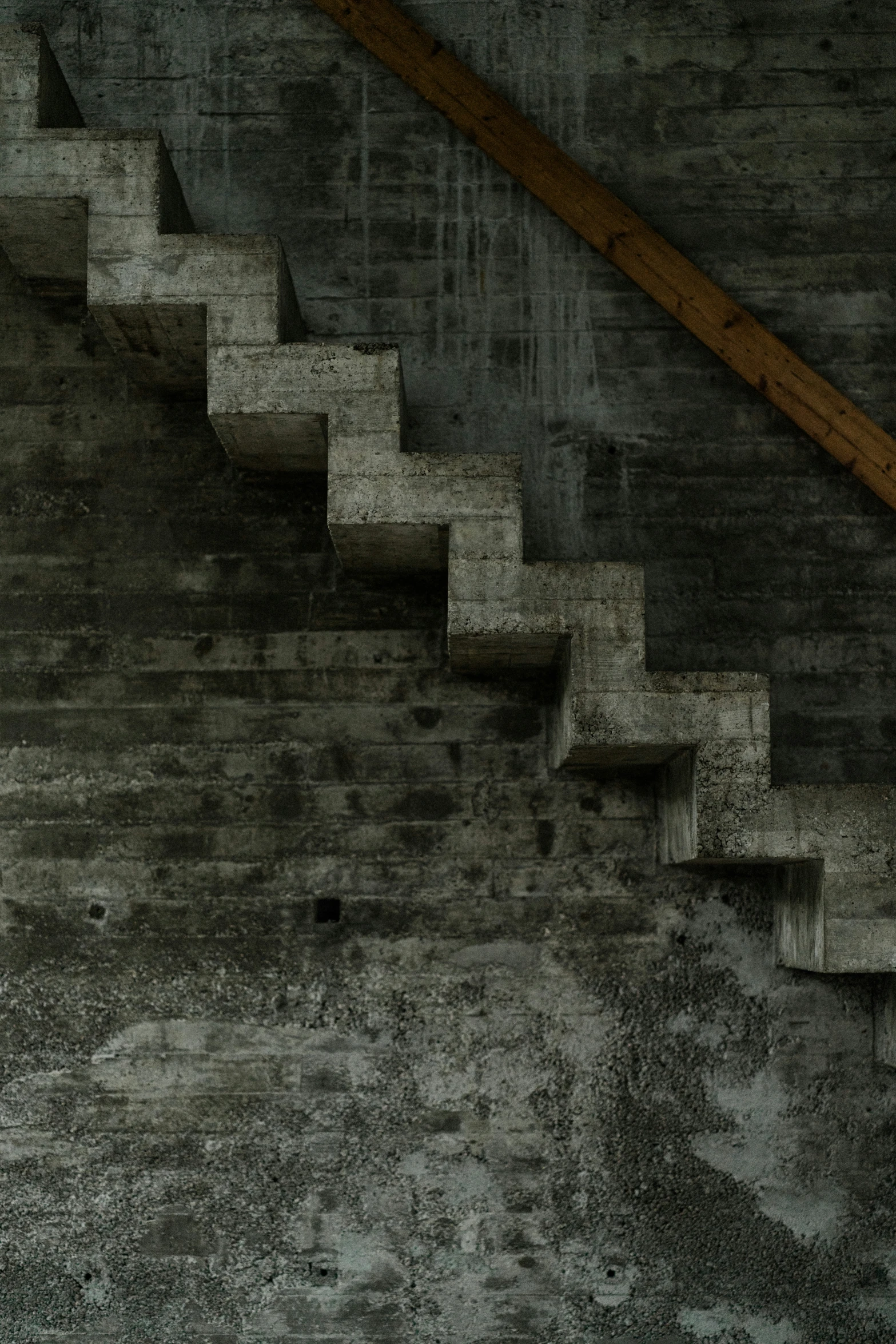 a staircase leading up to a wall in a dark place