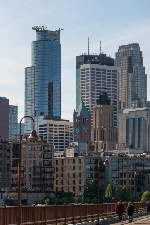 a city with tall buildings and a wooden fence