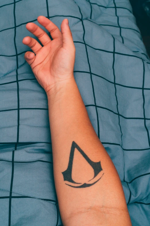 the arm and wrist of a person with a tattoo on it