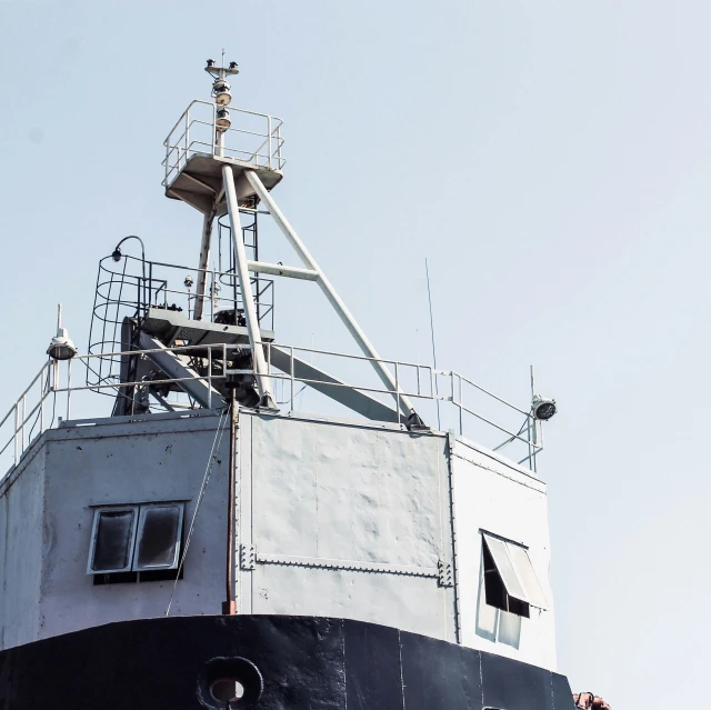 the front part of an empty ship with a small pilot on the deck