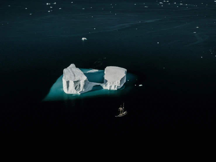 an aerial po of iceberg in the ocean