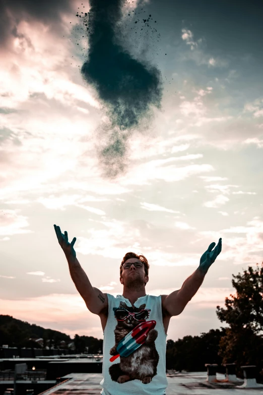 a man holding his hands in the air under a black cloud