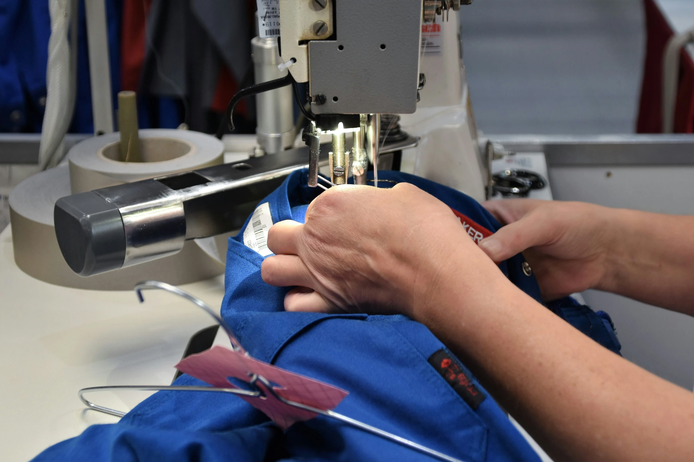 we are looking at a sewing machine working on the fabric