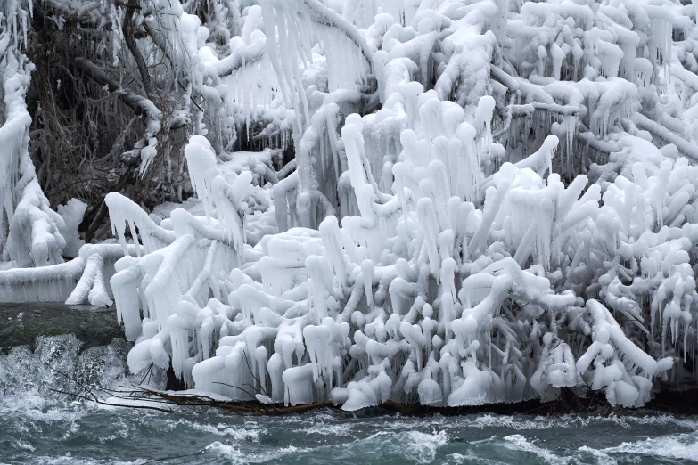 an icy cliff with the water frozen on top