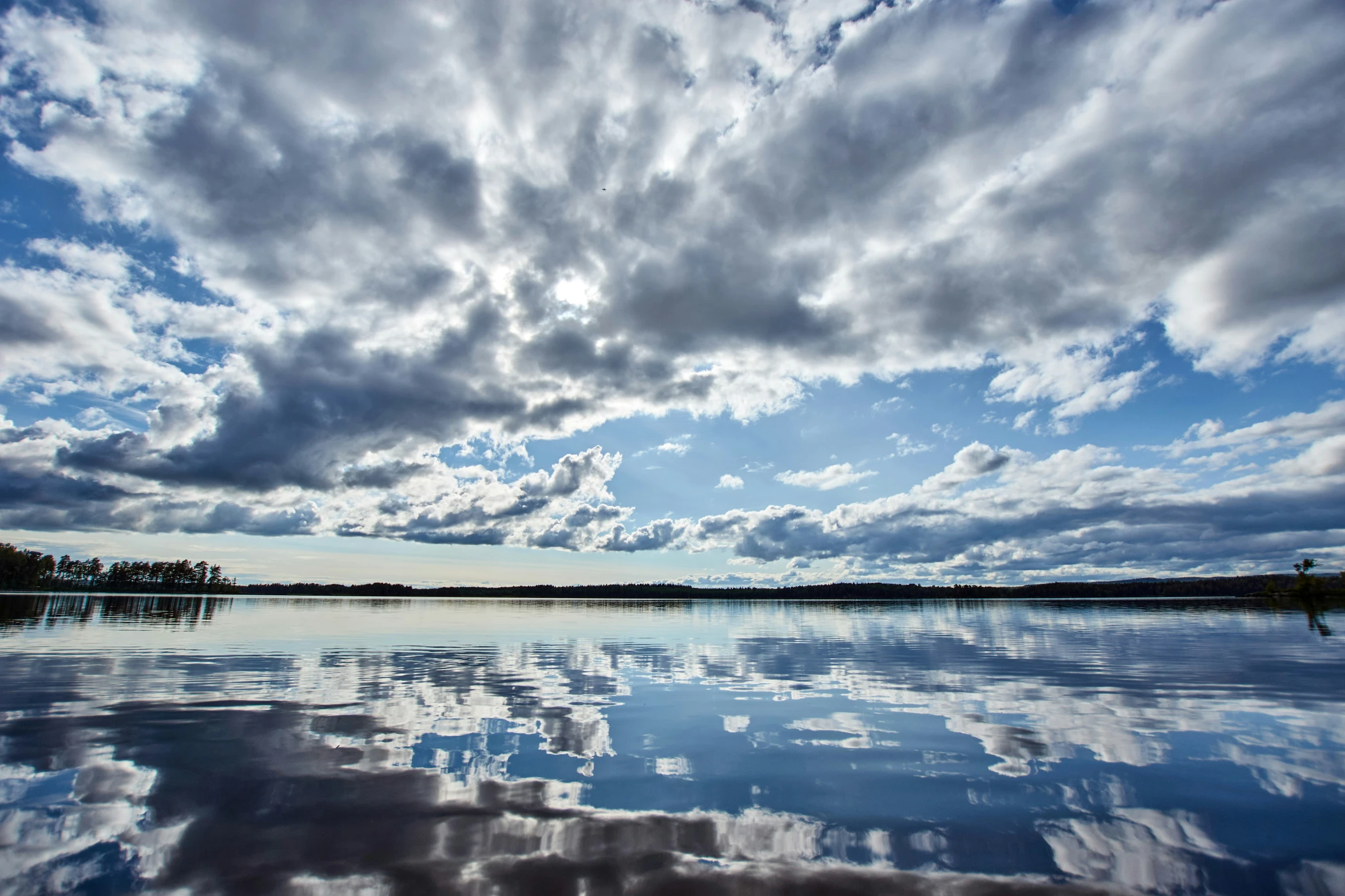 the sky is filled with clouds above water