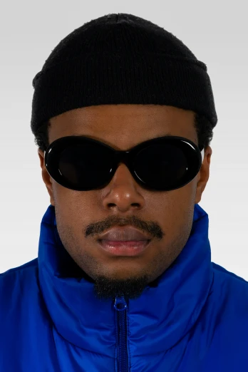 a man with dark sunglasses and a beanie