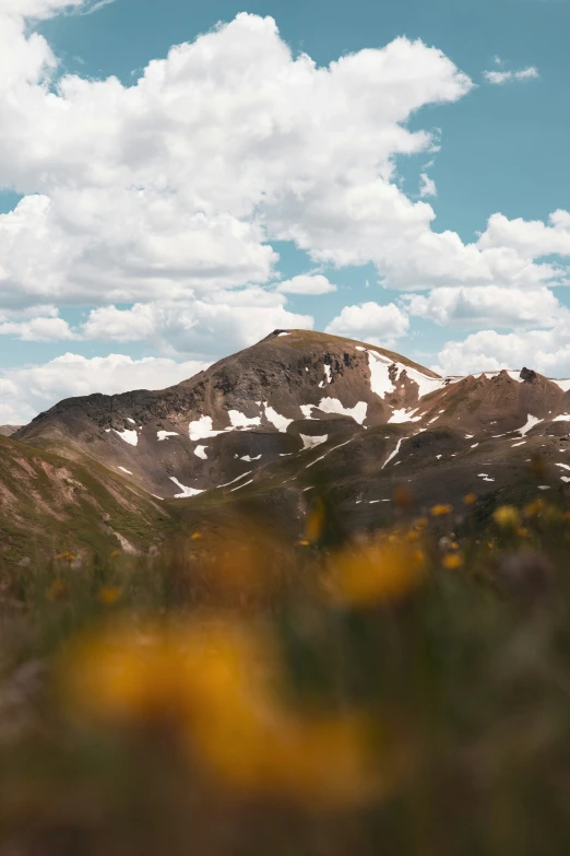 some mountains and a blue sky with clouds