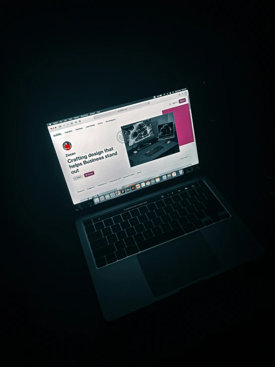 laptop with dark background and dark colored image