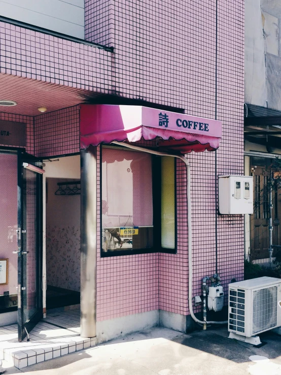 a street corner with a pink brick building