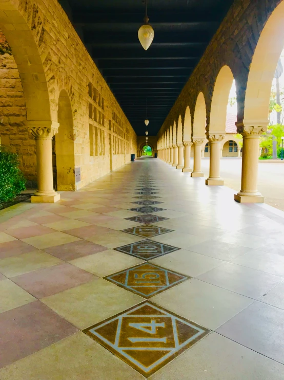 a large building has arched columns and decorative designs