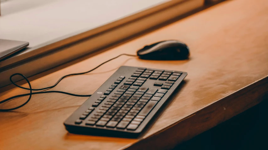 a computer mouse on a desk next to a keyboard