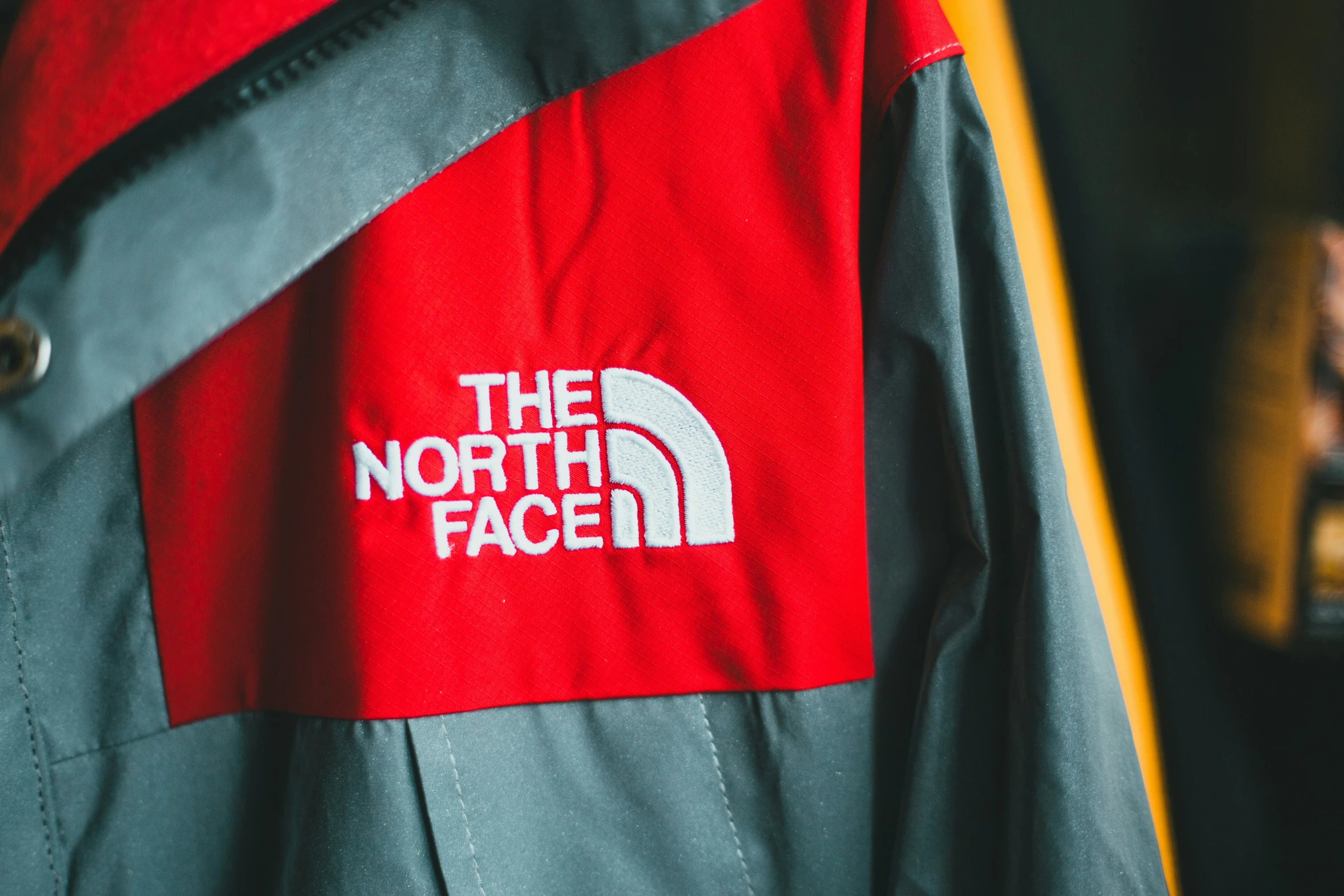 the north face jacket with red logo and grey outerwear