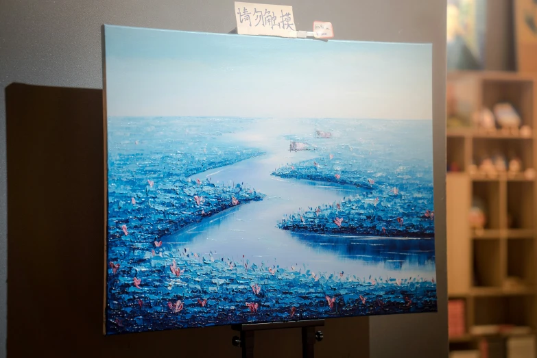 a large blue picture hangs from a stand