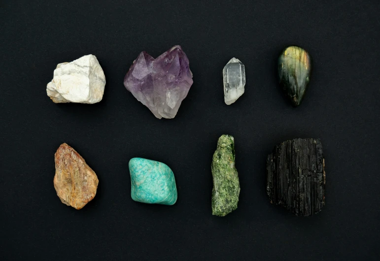 a selection of various types of rocks on a black background