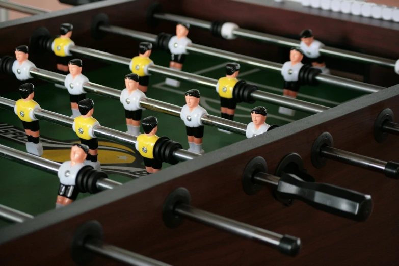 foose board table top foosball with miniature man figurines