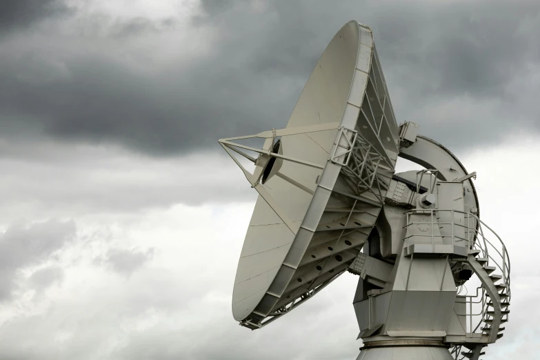 a very large satellite dish that is on top of a metal structure