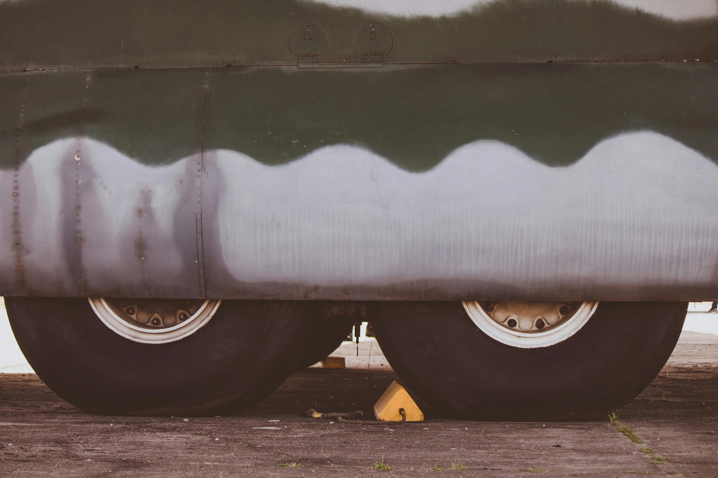 the rear wheels of a large bus that is parked on the ground