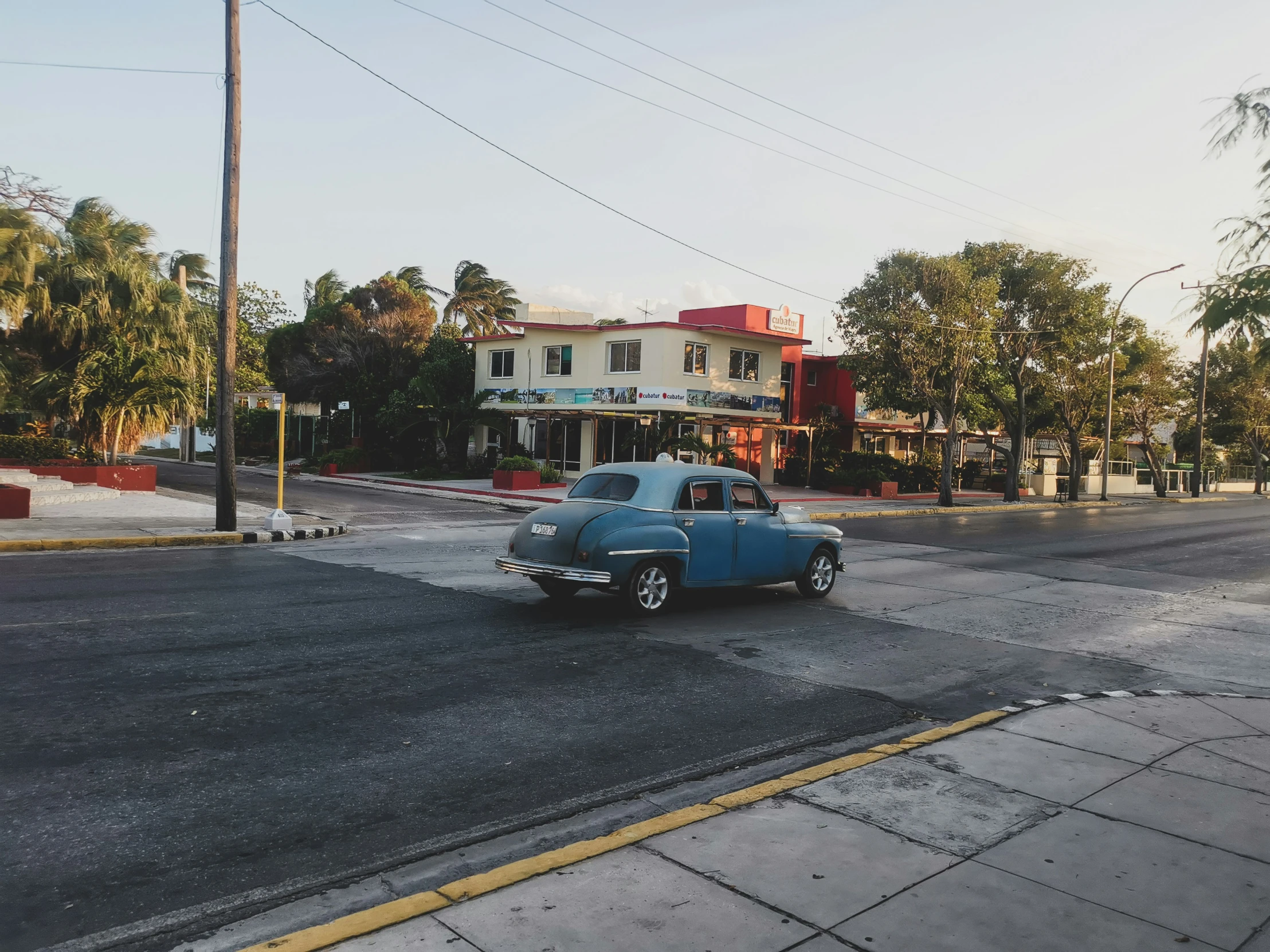 an old fashioned car is stopped in the middle of the road