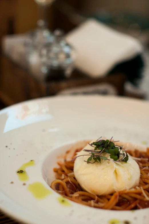 some food on a white plate at a restaurant