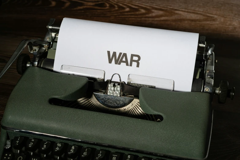 an old fashioned typewriter with war written on paper