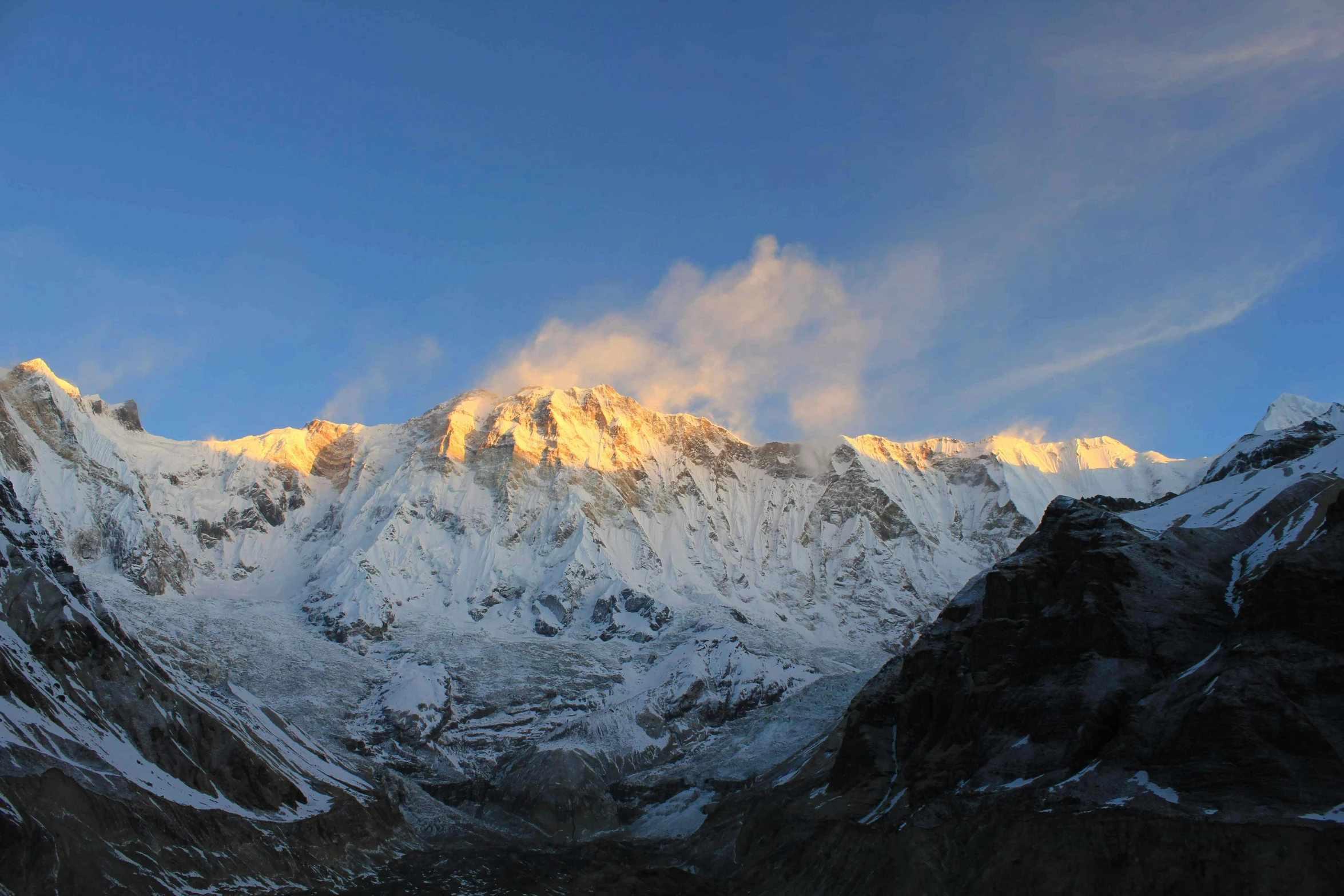 a snow - covered mountain range in winter on a clear day