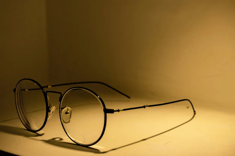 a pair of glasses sits on a shelf