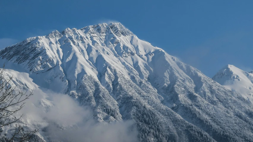 a large white mountain with snow on it