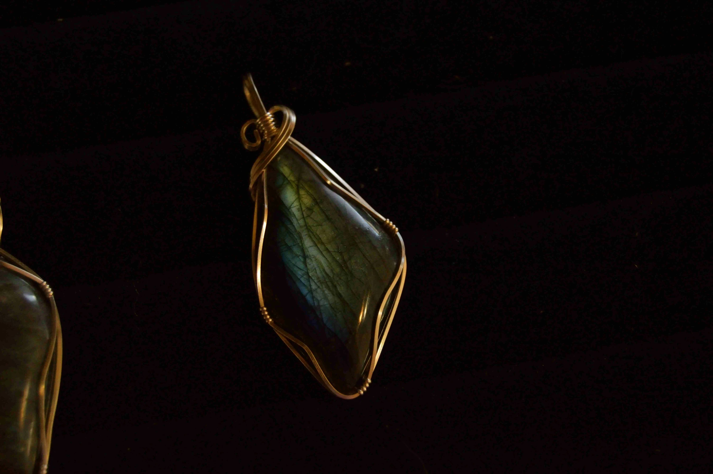 a beautiful pendant hangs from a piece of ss wire
