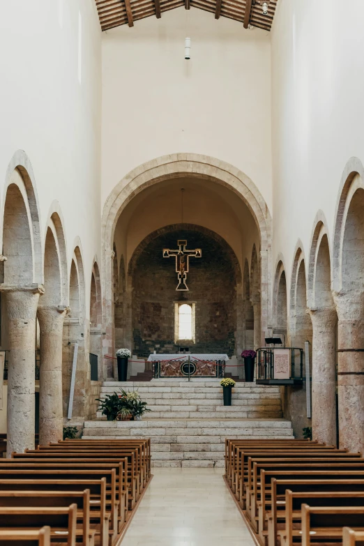 a church with an empty altar filled with pews