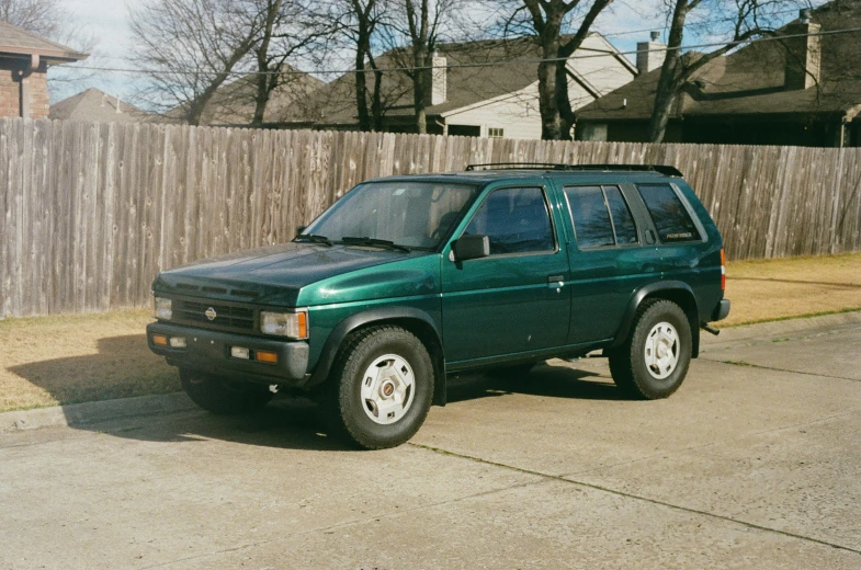 an suv is parked on the side of a road