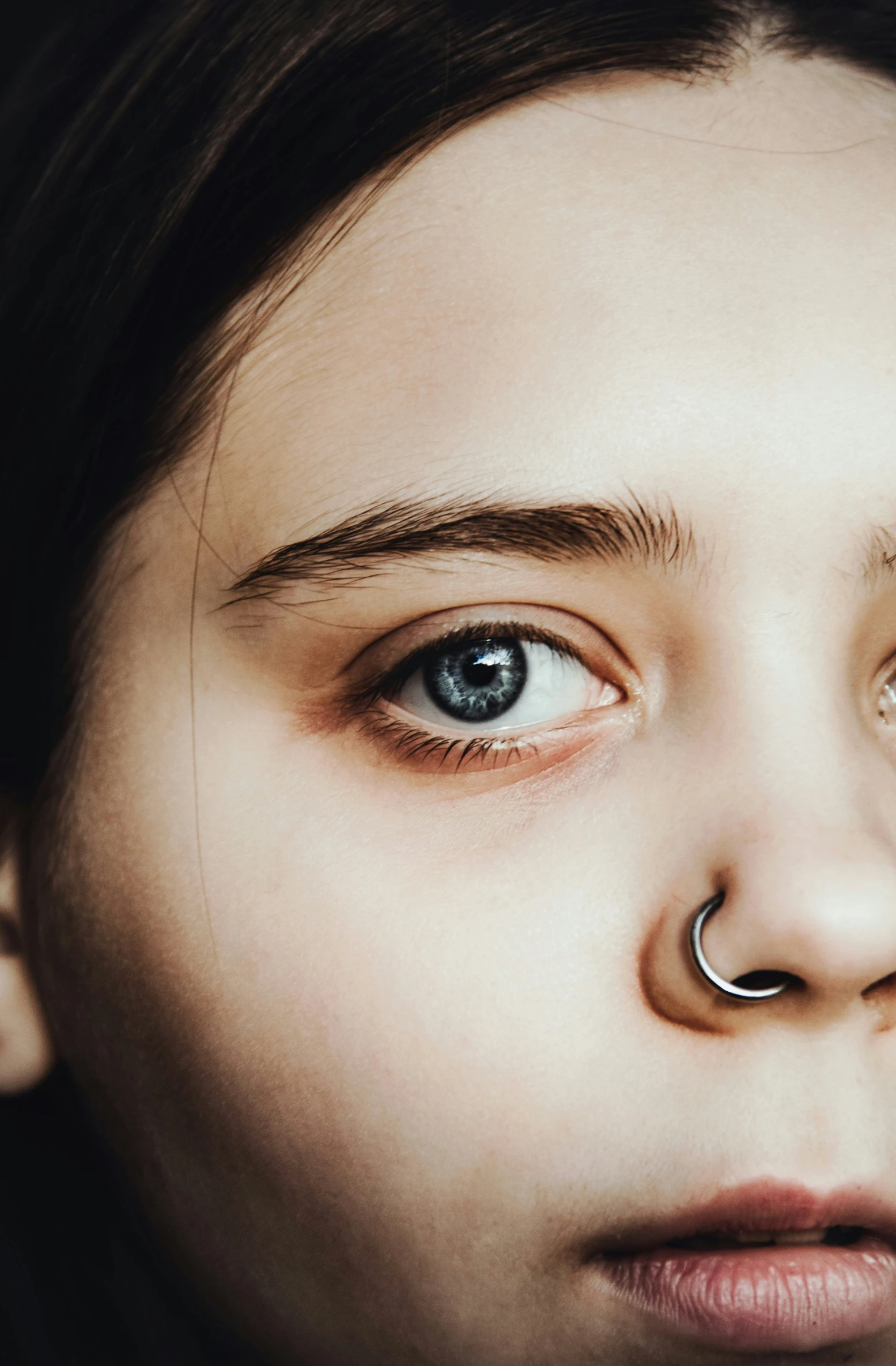 a young woman with a nose piercing on