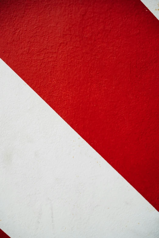 a red and white diagonal stripe with the center part painted yellow