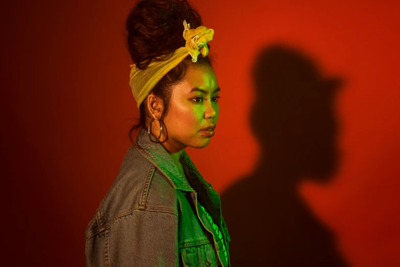 woman standing in silhouette, with red background and sun light