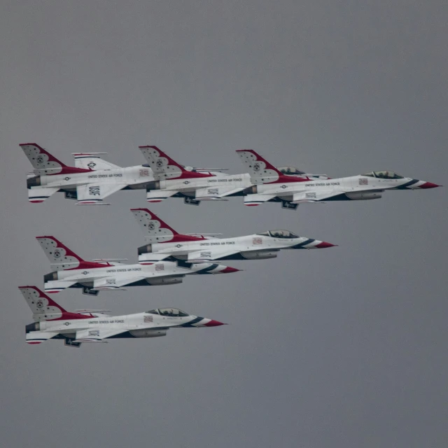 a group of fighter jets flying through the sky