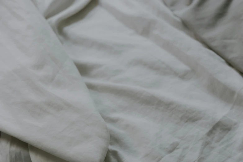 an image of a person laying in bed under the covers